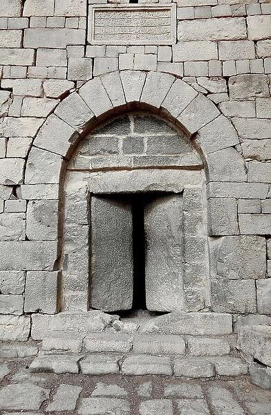 Stone door at Qasr al Azraq, Latin Basianis, Basienis, or Amatha, Blue Fortress, a historic Roman and Byzantine military camp on the anterior Limes Arabiae et Palaestinae, Desert Castle, Azraq, Jordan
