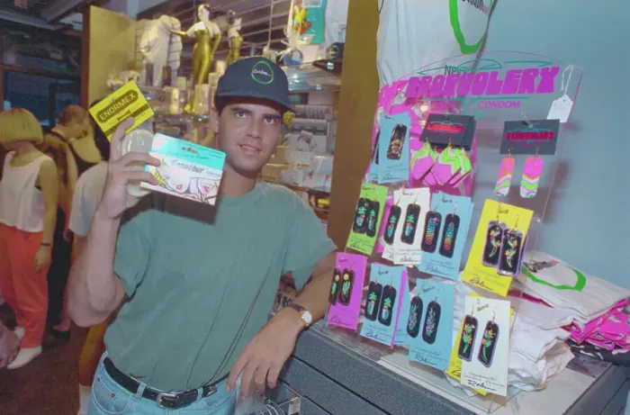 Framed Print : Store Owner Holding Condom Box