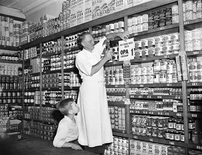 Framed Print : Store Owner Putting Sign Up In Grocery Framed Print : Store Owner Putting Sign Up In Grocery