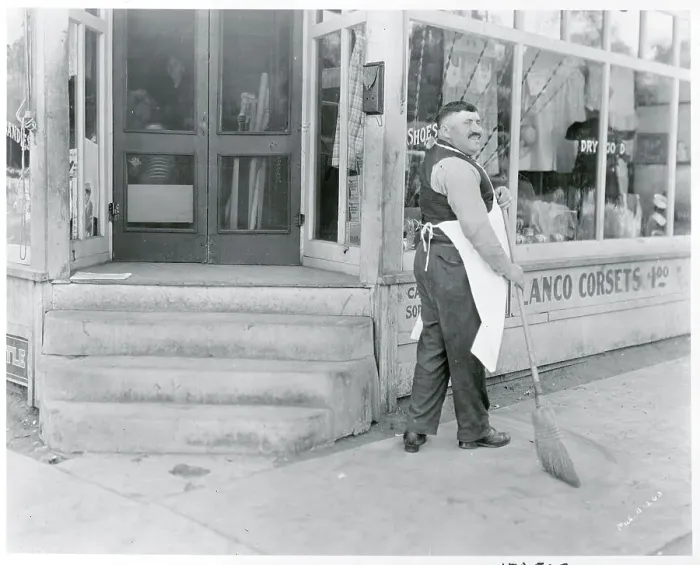 Framed Print : Store Owner Sweeping Sidewalk Framed Print : Store Owner Sweeping Sidewalk