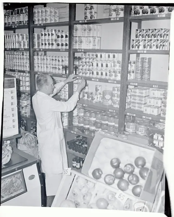 Framed Print : Storekeeper Adjusting Stock Framed Print : Storekeeper Adjusting Stock
