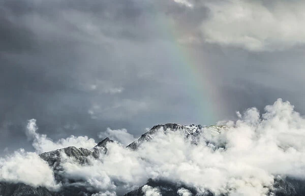 Storm clouds with a rainbow, Southern Alps, Fox Glacier, South Island, New Zealand