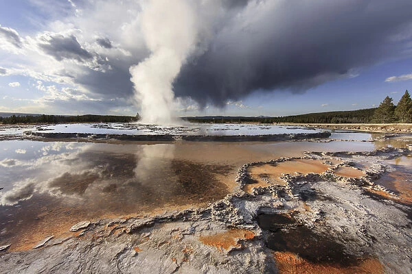 Stormy clouds over Great Fountain Geyser, Yellowstone National Park, Wyoming, USA