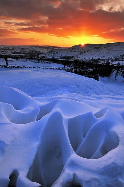 Strange natural snow formations at sunset with the Derbyshire countryside. UK