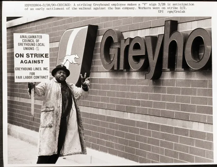 Framed Print : Striker Stands Beside Greyhound Sign