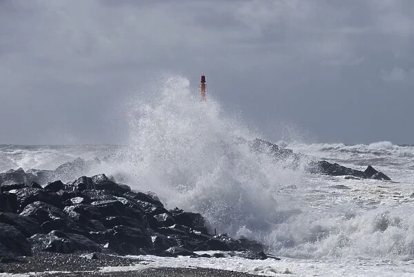 Strong waves with spray in a storm at the pier of Hvide Sande, Jutland, Denmark, Europe