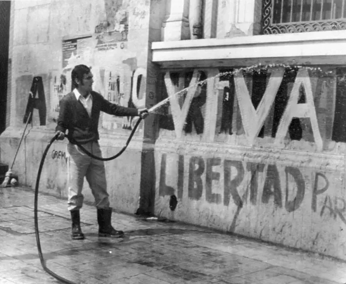 Framed Print : Student Hoses Down Viva Libertad Sign Framed Print : Student Hoses Down Viva Libertad Sign