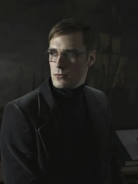 Framed Print : Student wearing a suit and glasses, sitting in front of a painting Framed Print : Student wearing a suit and glasses, sitting in front of a painting
