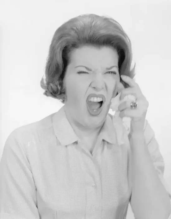 Framed Print : Studio portrait of mid adult woman sneezing Framed Print : Studio portrait of mid adult woman sneezing