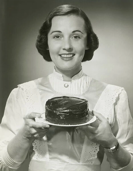 Studio portrait of woman holding cake