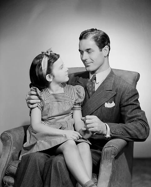 Studio shot of father and daughter (10-11 years) looking in eyes