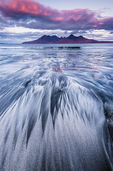 Stunning sand formations on the Isle of Eigg with the Isle of Rum in the distance. Scotland