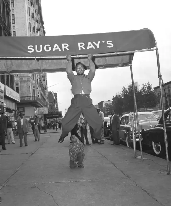 Framed Print : Sugar Ray Robinson Hanging From a Awning Framed Print : Sugar Ray Robinson Hanging From a Awning