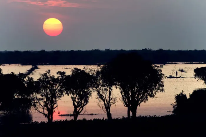 Framed Print : the Sun coming down over tonle sap lake and Fisherman fishing on the boat Framed Print : the Sun coming down over tonle sap lake and Fisherman fishing on the boat