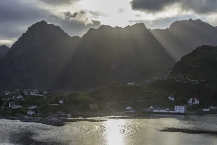 Framed Print : Sun rays breaking through the clouds over the mountains of the municipality of Moskenes, Lofoten, Nordland, Norway Framed Print : Sun rays breaking through the clouds over the mountains of the municipality of Moskenes, Lofoten, Nordland, Norway