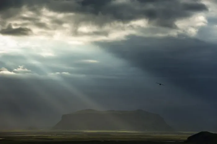 Framed Print : Sun rays shining through clouds, moody lighting, South Coast, Iceland, Europe Framed Print : Sun rays shining through clouds, moody lighting, South Coast, Iceland, Europe