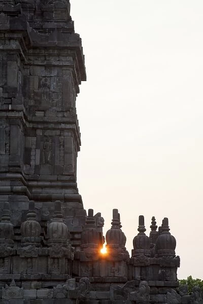 Sun setting through a Prambanan temple