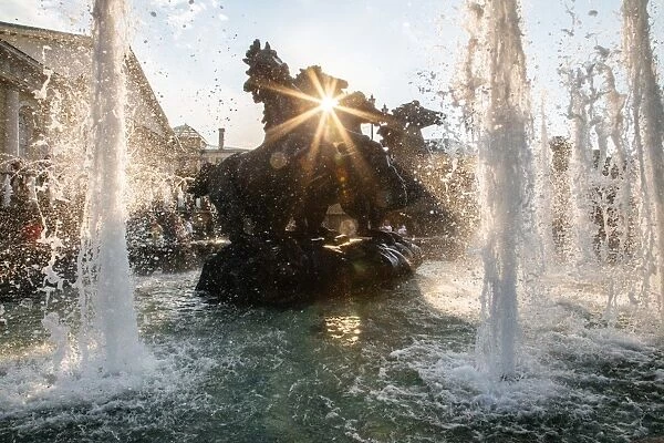 Sun is shining though the Four Seasons fountain on Manezhnaya Square in Moscow
