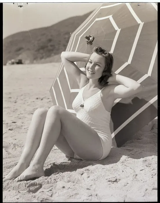 Framed Print : Sunbather Leaning Against Umbrella Framed Print : Sunbather Leaning Against Umbrella