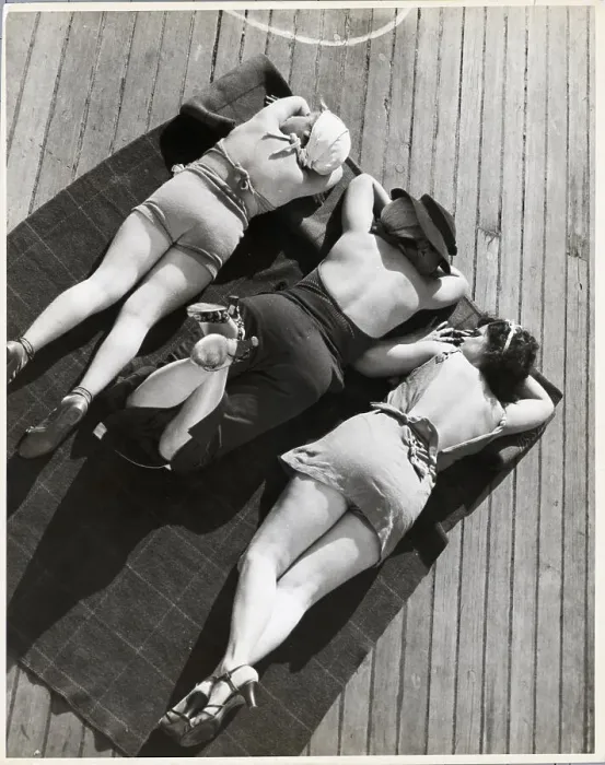 Framed Print : Three Sunbathers on Towel on Deck of Ship
