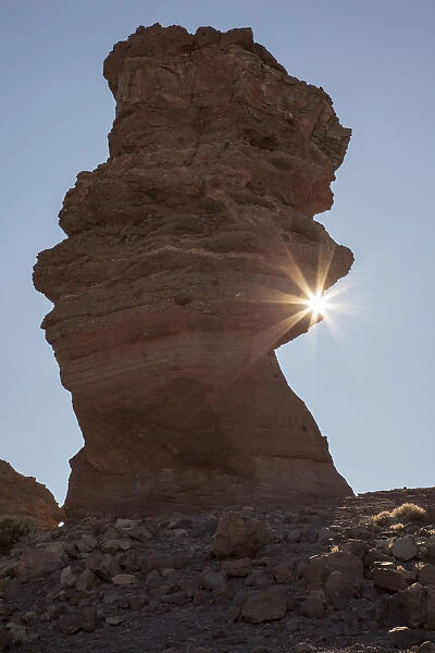 Sunburst touching a rock spire in Teide
