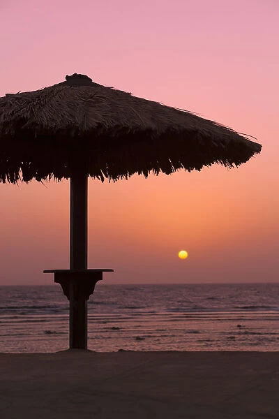 Sunrise with beach parasol, Dahab, Egypt, Africa