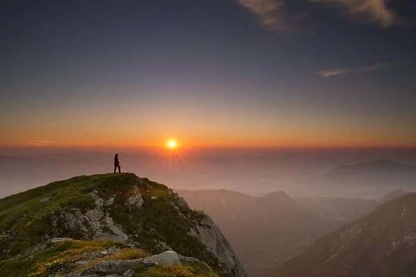 Sunset with hiker on a summit of the Allgau Alps, Oberstdorf, Bavaria, Germany