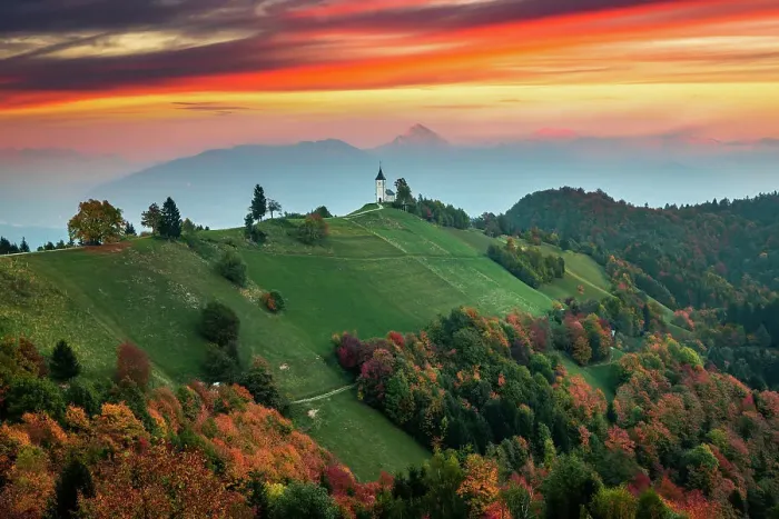 Framed Print : Sunset landscape of church Jamnik in Slovenia on green hill with mountains background Framed Print : Sunset landscape of church Jamnik in Slovenia on green hill with mountains background