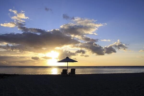Sunset on the public beach of Flic en Flac on the western coast of Mauritius, Africa