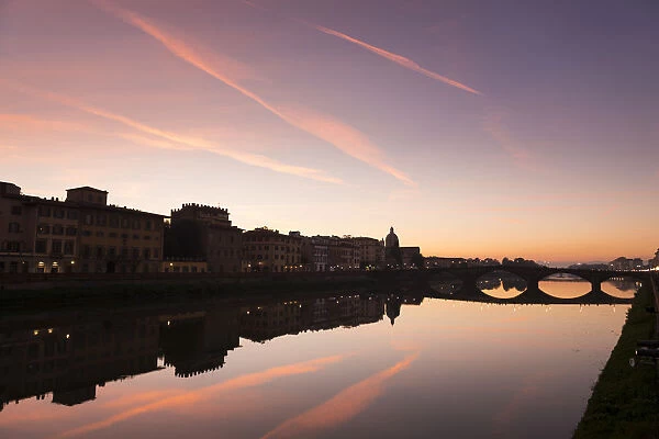 Sunset view of River Arno with buildings along the riverbank
