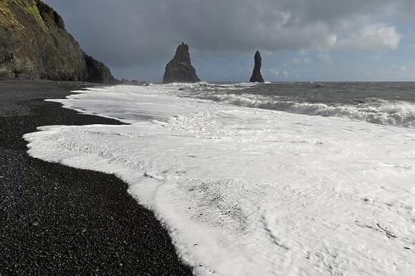 Surf on the black lava beach of Reynisfjara, Reynisdrangar Pinnacles, near Vik i Myrdal, South Coast, Iceland