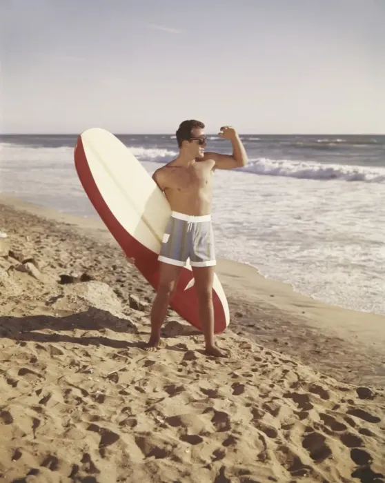 Framed Print : Surfer holding surfboard on beach Framed Print : Surfer holding surfboard on beach