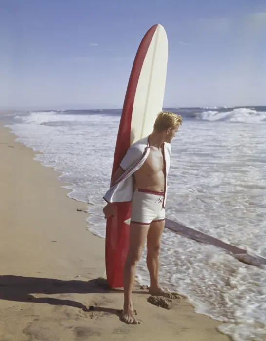 Framed Print : Surfer holding surfboard on beach Framed Print : Surfer holding surfboard on beach