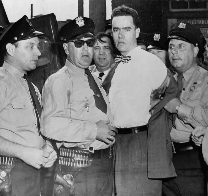 Framed Print : Suspect Being Guarded by Police Framed Print : Suspect Being Guarded by Police