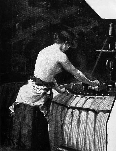 Sweatshop. 1896: A woolcomber working in hot conditions is stripped to the waist