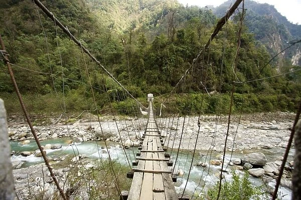 Swing bridge across a river at low water, Annapurna Conservation Area, Nepal, Asia