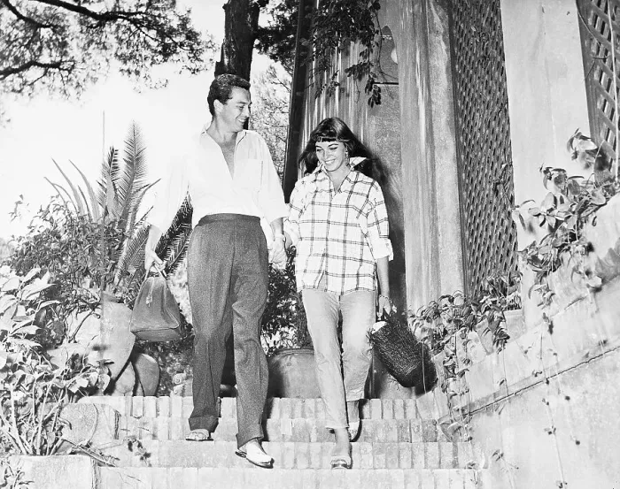 Framed Print : Sydney Chaplin and Joan Collins Walking