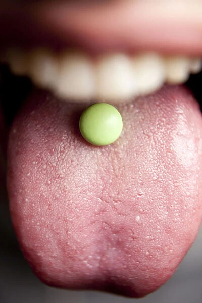 Tablet, pill on a tongue, mouth