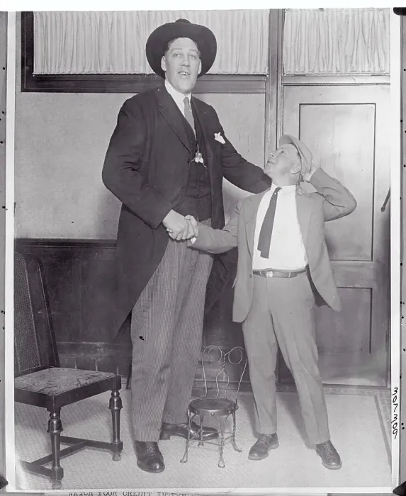 Framed Print : Tall Man Shaking Hand of Friend Framed Print : Tall Man Shaking Hand of Friend