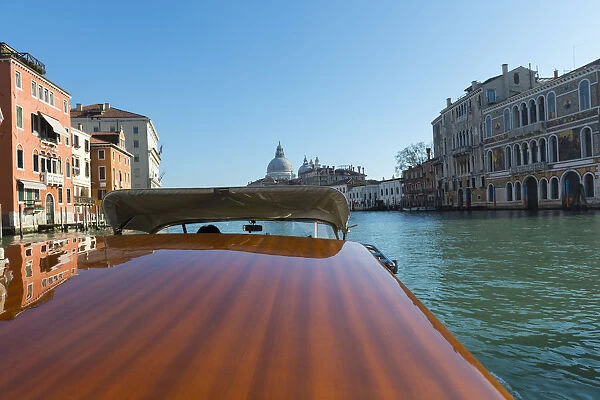 Taxi boat on Grand Canal and church Salute in Venice, Italy
