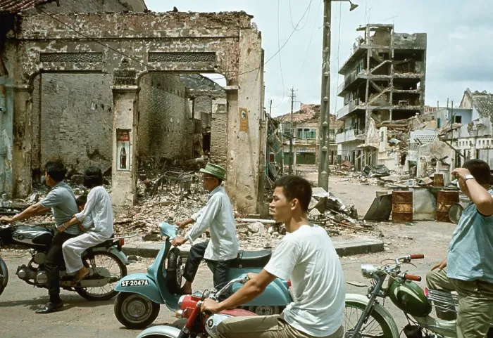 Framed Print : Taxis and Moped Pass Flattened Building Framed Print : Taxis and Moped Pass Flattened Building