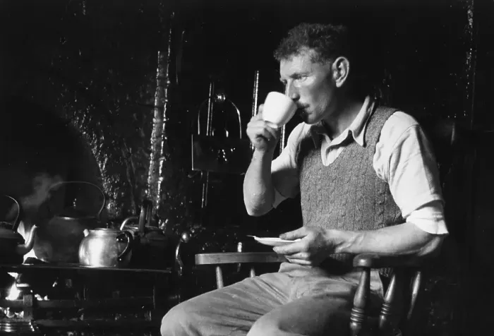 Framed Print : Tea Break. 11th August 1951: A man has a cup of tea by a kitchen range Framed Print : Tea Break. 11th August 1951: A man has a cup of tea by a kitchen range