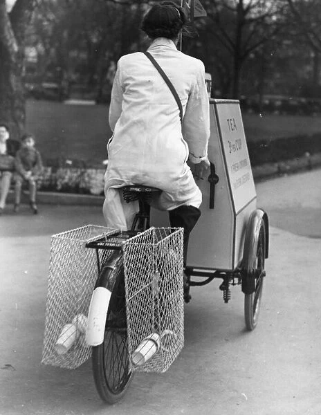 Tea Cycle. A woman rides a cycle tea trolley through the London Zoo