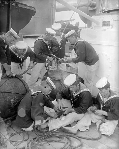 Teamwork. circa 1897: Sailors knotting and splicing rope on board the HMS Repulse