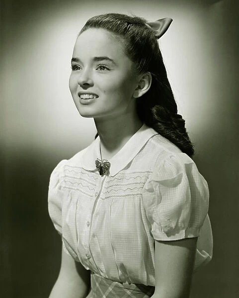 Teenage girl (14-15) with long hair, (B&W), portrait