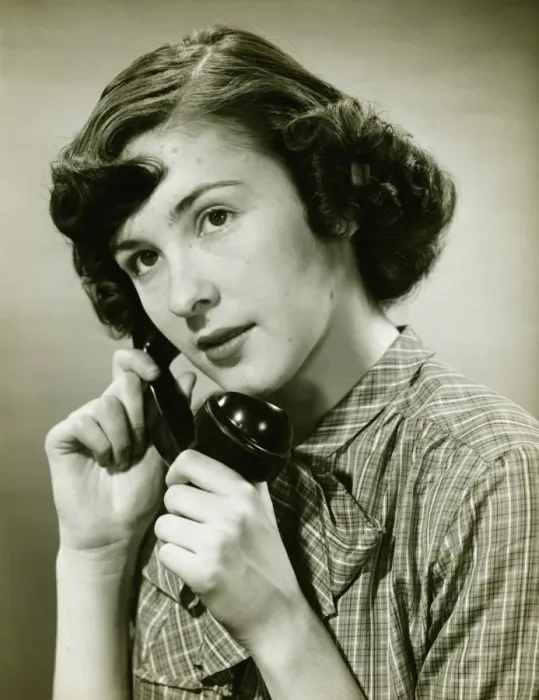 Framed Print : Teenage girl (16-17) on phone posing in studio, (B&W), portrait Framed Print : Teenage girl (16-17) on phone posing in studio, (B&W), portrait