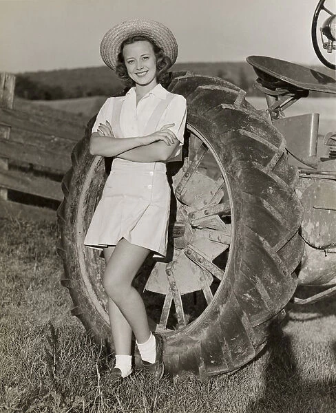 Teenage girl with farm tractor