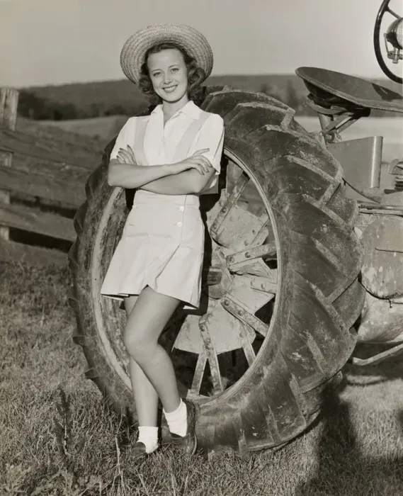 Framed Print : Teenage girl with farm tractor Framed Print : Teenage girl with farm tractor