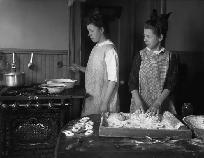 Framed Print : Teenage girls (15-17 years) making doughnuts in kitchen. August 06, 1925 Framed Print : Teenage girls (15-17 years) making doughnuts in kitchen. August 06, 1925