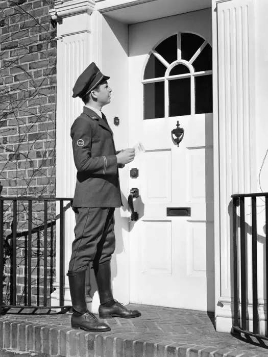 Framed Print : Teenage messenger boy delivering message at front door Framed Print : Teenage messenger boy delivering message at front door